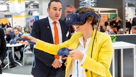 Photo of a woman with VR glasses at the stand