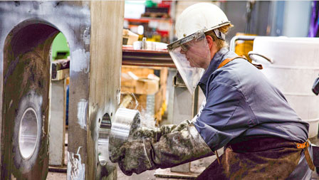 Nitrogen cooled bushing for the steel mill Photo of an employee inserting a bushing into a hook fork